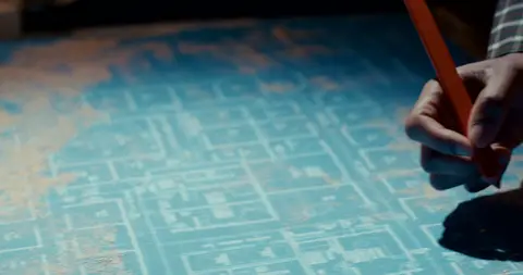 Strong blueprint/planning detail with hand and clear work-prep context.