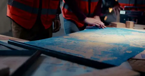 Useful blueprint/table setup, but less direct than the stronger hand-on-plan detail.
