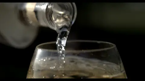 Third-pass frame candidate. Source-level review: Bottle, pour, and glass frames are composed and polished, but this remains alcohol/product-label material and needs category review. Individual frame still requires close visual review unless source-level decision is reject.