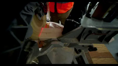 Third-pass frame candidate. Source-level review: Strong industrial/worksite material with hard hats, tools, sparks, and construction texture. Avoid screen/plan/text-heavy frames. Individual frame still requires close visual review unless source-level decision is reject.