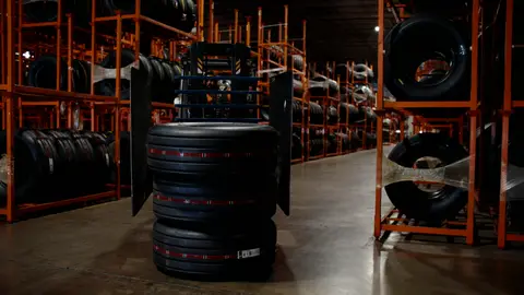 Third-pass frame candidate. Source-level review: Strong warehouse/tire/forklift material with better subject clarity than earlier passes. The orange fast-pan smear and obstructed worker frames are explicitly excluded. Individual frame still requires close visual review unless source-level decision is reject.