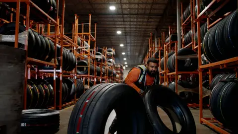 Third-pass frame candidate. Source-level review: Strong warehouse/tire/forklift material with better subject clarity than earlier passes. The orange fast-pan smear and obstructed worker frames are explicitly excluded. Individual frame still requires close visual review unless source-level decision is reject.