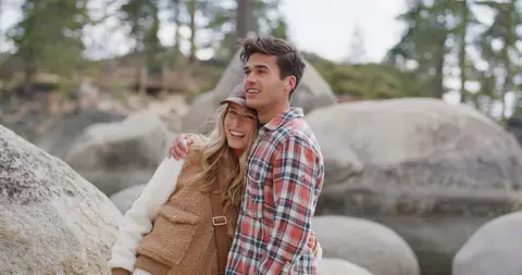 USPA Fleece Couple Seated On Rocks. lifestyle visual reference, composition and color reference.