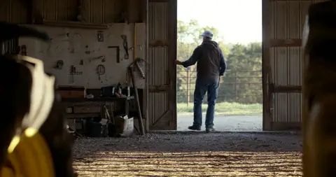 Wide barn doorway silhouette has atmosphere but is less direct as a library still.