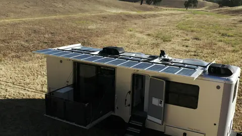 Strong elevated exterior showing deployed entry and solar roof detail.
