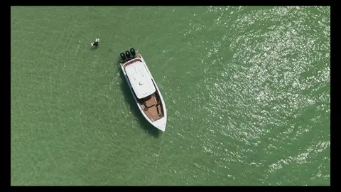 Strong overhead boat-on-water frame with clean geometry and readable subject.