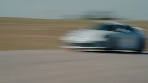 Panning Porsche pass has useful speed and lateral energy, but heavy blur limits still-frame use.