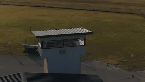 Strong aerial control-tower move with clear parallax and track context.