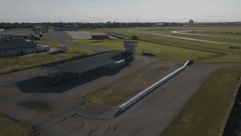 Useful aerial facility pass with visible parallax and track context.