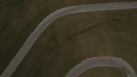Strong top-down drone move across graphic track curves.