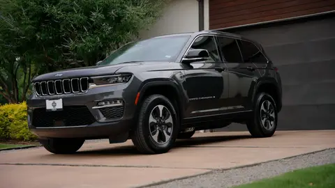 Strong full-vehicle driveway hero with clean body shape and environment.