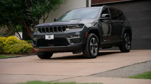 Strong full-vehicle side/front driveway hero with readable shape and better context than the tighter details.