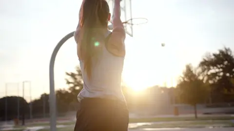 Backlit basketball setup has mood but the subject is less readable.