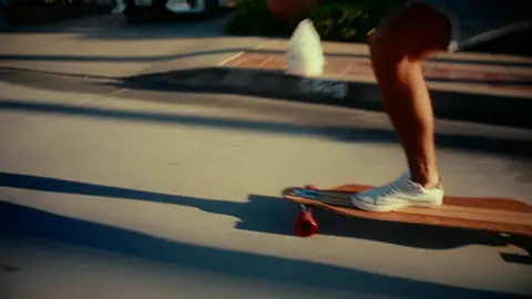 Strong skateboard/footwear detail with clean motion story and readable subject.
