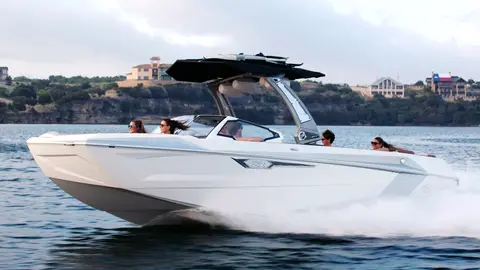 Strong Tige boat hero profile with clean side view, water spray, riders, and marina context.