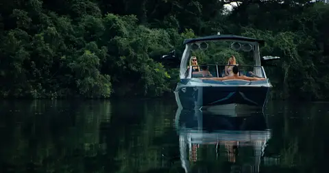 Strong rear boat hero with clean reflection, readable boat shape, and lake setting.