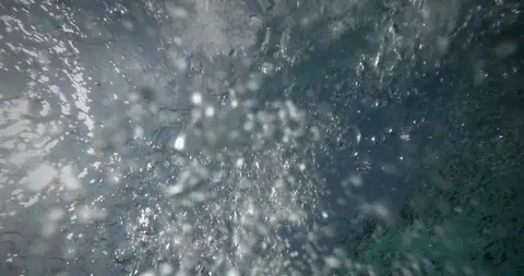 Abstract underwater texture has motion and atmosphere but no clear subject.
