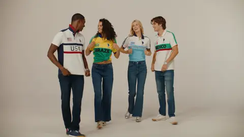 Four adults wear USA, Brazil, Argentina and Mexico polo shirts with jeans as they face one another in a neutral studio.
