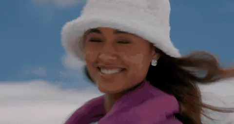 A fast winter montage moves from a smiling woman to an urban lamp and a woman beside a horse.